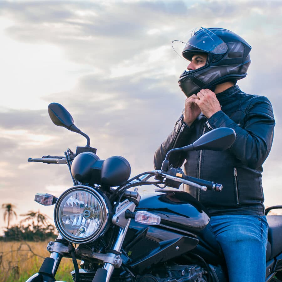 Motorcycle Rider Putting on Helmet