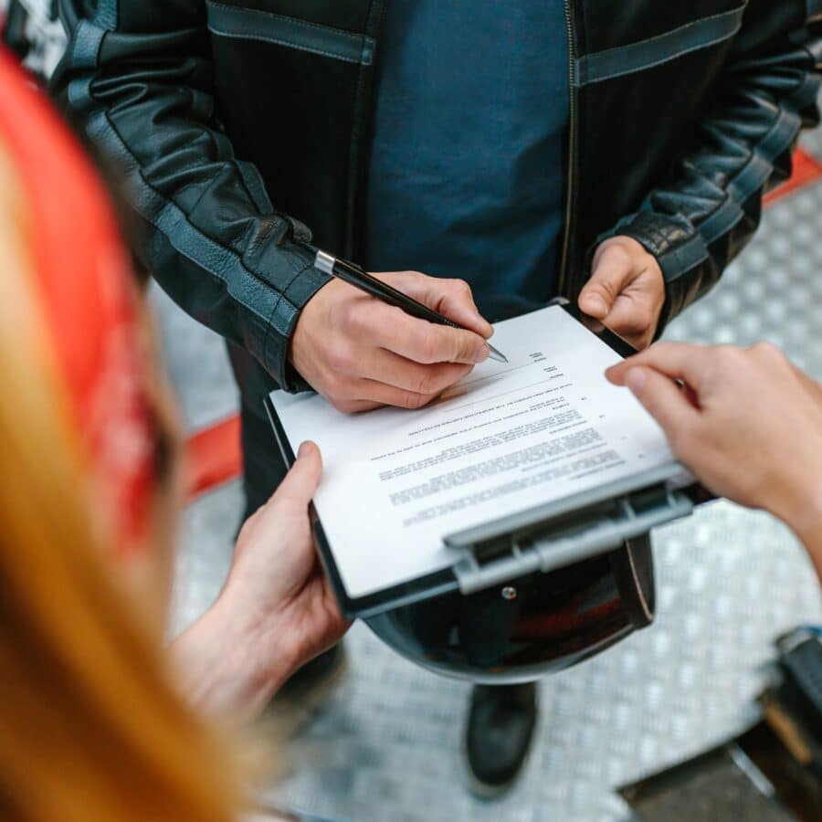 Motorcyclist filling out insurance forms